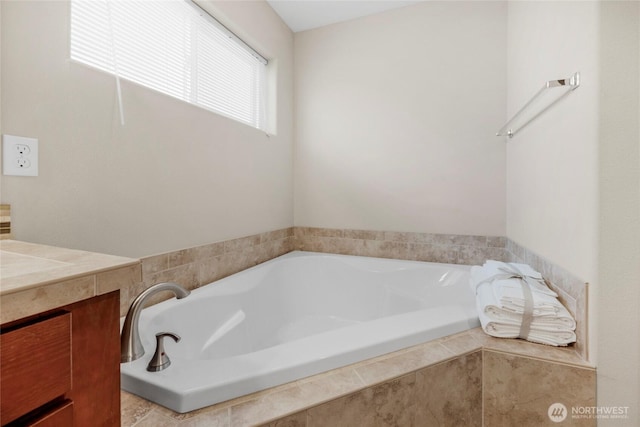 bathroom featuring a bath and vanity