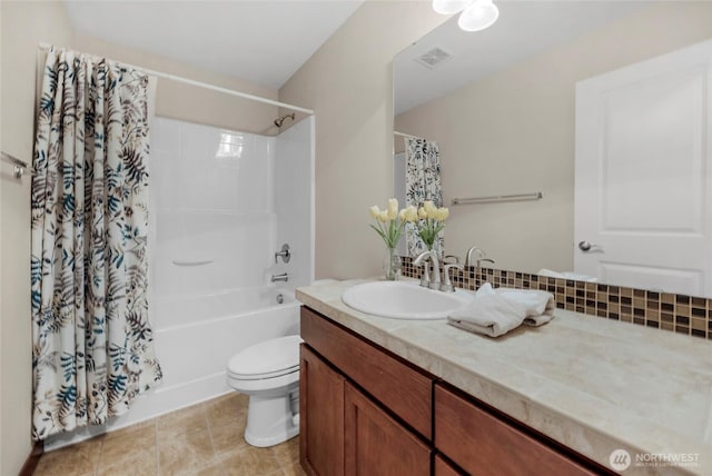 bathroom with vanity, visible vents, tile patterned flooring, shower / bath combo with shower curtain, and toilet