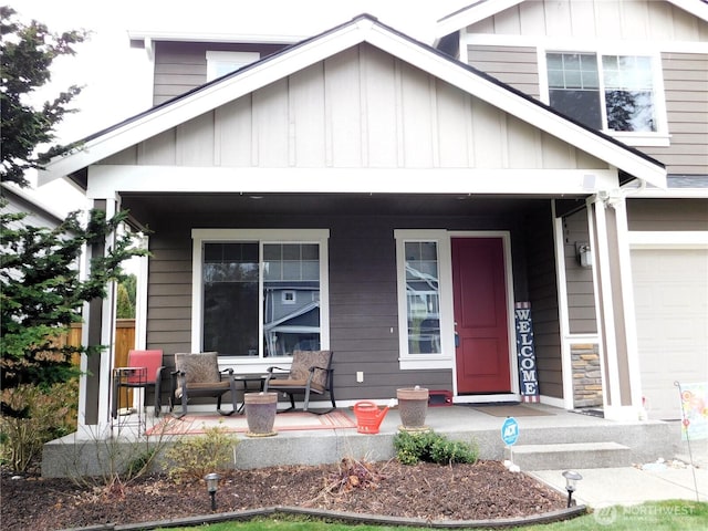 view of front of property with a garage, board and batten siding, and covered porch