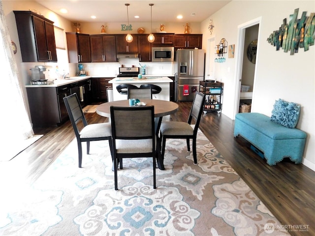 dining area with recessed lighting, baseboards, and wood finished floors