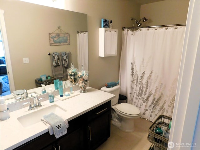 bathroom with vanity, a shower with shower curtain, and toilet