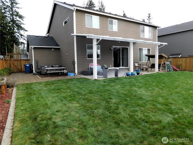 back of property featuring a playground, fence, a lawn, and a patio area