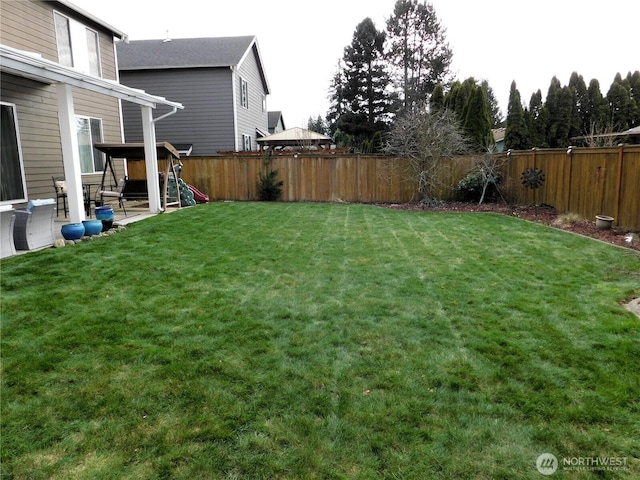 view of yard with a fenced backyard