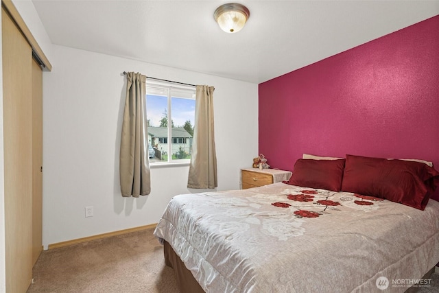carpeted bedroom featuring baseboards