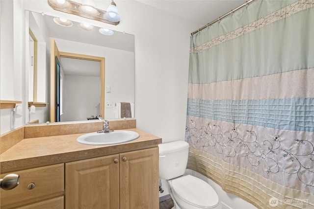 bathroom featuring vanity, a shower with shower curtain, and toilet
