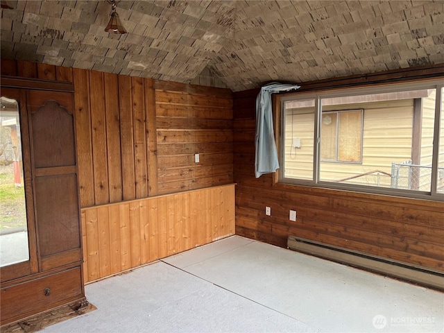 empty room featuring a baseboard radiator, brick ceiling, lofted ceiling, and wood walls