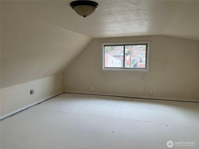 additional living space featuring lofted ceiling