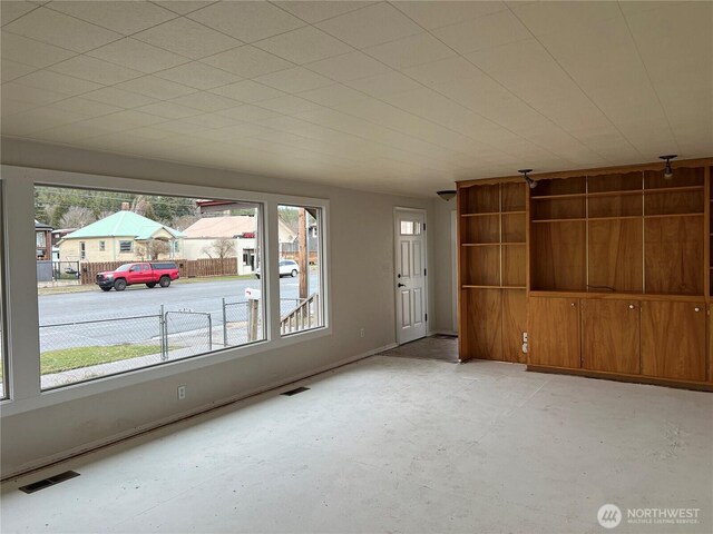 interior space featuring unfinished concrete flooring and visible vents