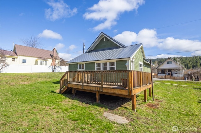 308 S 1st St, Roslyn, WA 98941 - rear view of property featuring a wooden deck, fence, a yard, and metal roof