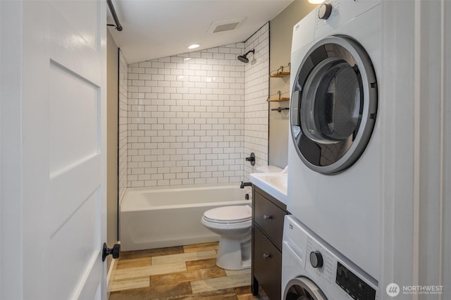 308 S 1st St, Roslyn, WA 98941 - bathroom featuring toilet, visible vents, shower / bath combination, stacked washer and clothes dryer, and vanity