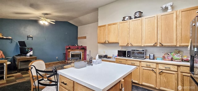 kitchen featuring light brown cabinets, stainless steel appliances, a toaster, ceiling fan, and light countertops