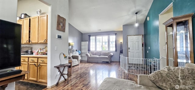 living room with baseboards, lofted ceiling, and dark wood-style floors