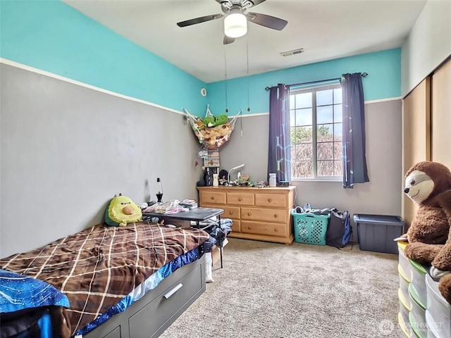 bedroom featuring carpet flooring, a ceiling fan, and visible vents