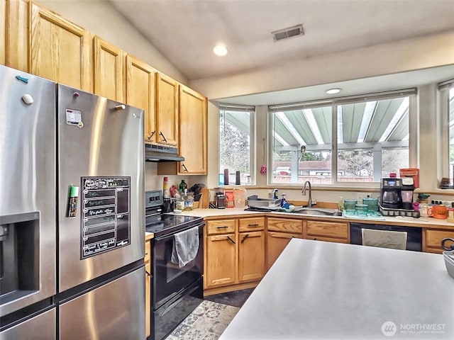 kitchen featuring visible vents, under cabinet range hood, light countertops, stainless steel refrigerator with ice dispenser, and black / electric stove