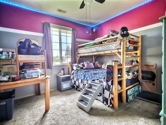 carpeted bedroom featuring visible vents and ceiling fan