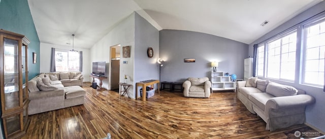 living room with visible vents, lofted ceiling, and dark wood finished floors