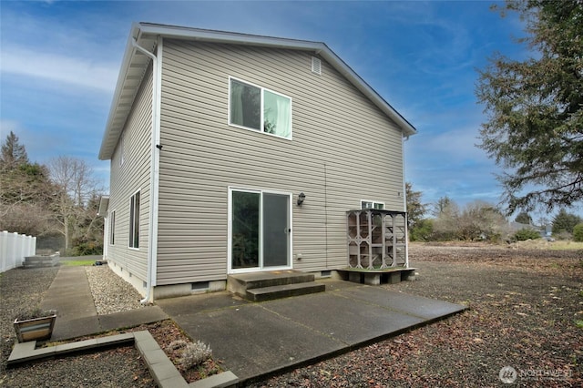 back of house featuring crawl space and entry steps
