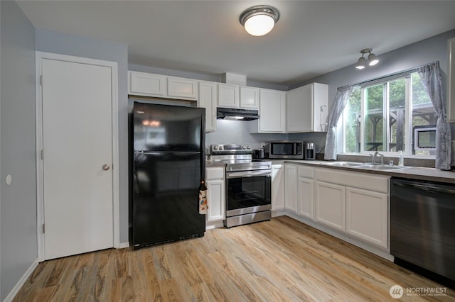 kitchen featuring under cabinet range hood, white cabinets, appliances with stainless steel finishes, and a sink