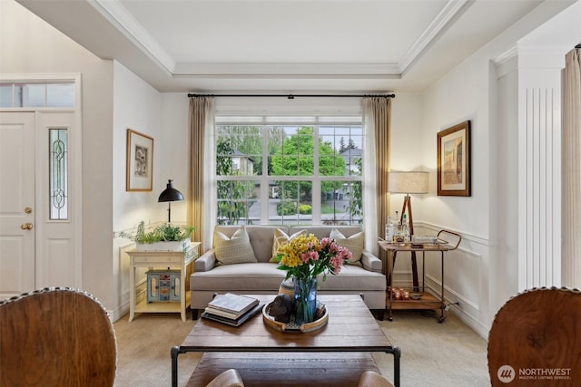 sitting room featuring ornamental molding, a tray ceiling, and light colored carpet