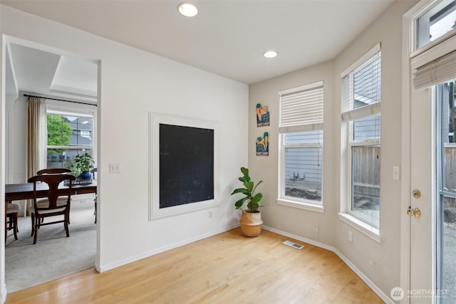 empty room with recessed lighting, baseboards, light wood-type flooring, and visible vents