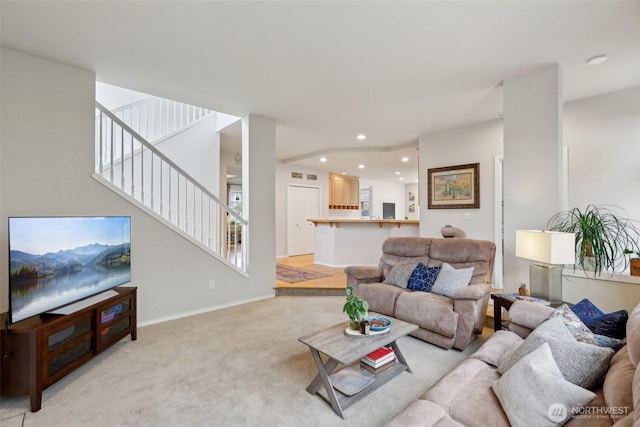 living area featuring recessed lighting, baseboards, light carpet, and stairway