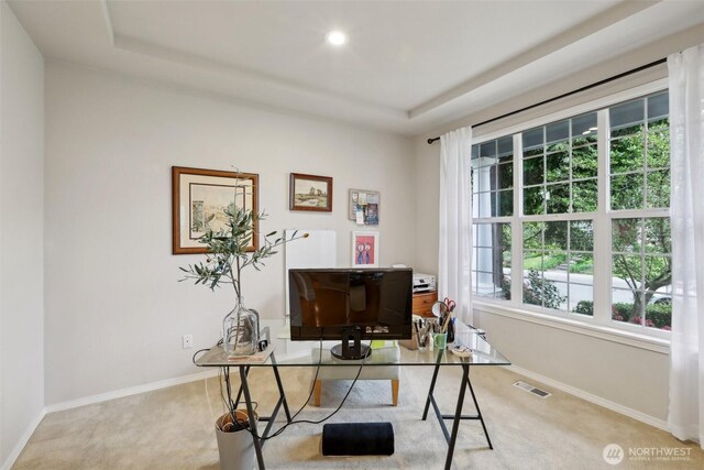 office area with carpet flooring, recessed lighting, baseboards, a tray ceiling, and visible vents