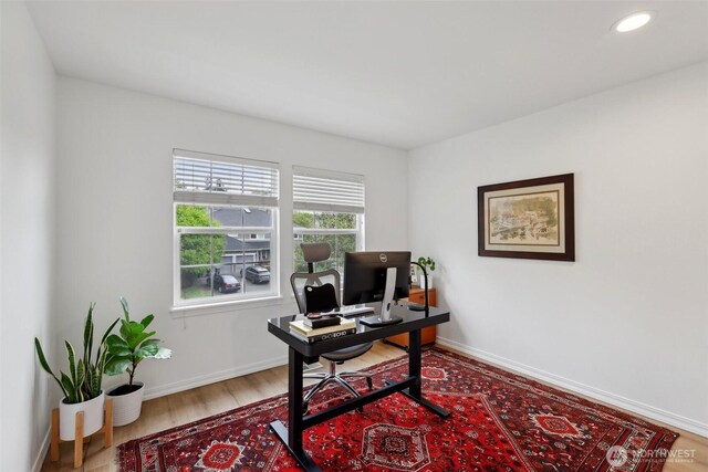 office space featuring baseboards, recessed lighting, and wood finished floors