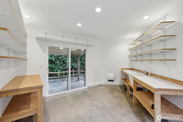office space featuring recessed lighting, baseboards, and concrete floors