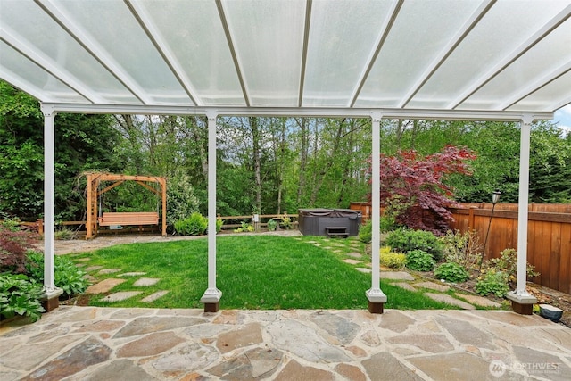 view of yard featuring a hot tub, a patio, and fence