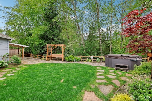 view of yard featuring a patio, a hot tub, and fence