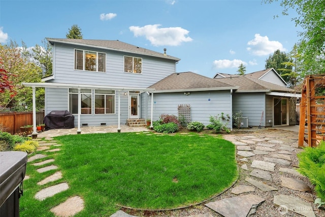 rear view of house featuring a lawn, a patio, fence, and entry steps