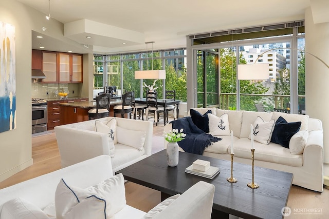 living room featuring light wood finished floors and recessed lighting