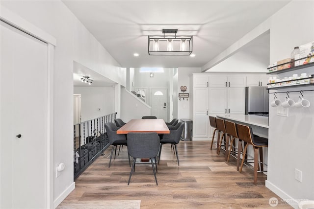 dining space featuring light wood-style floors