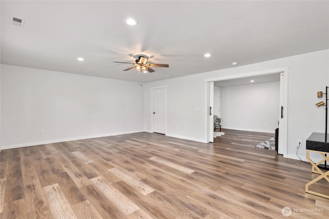 interior space featuring recessed lighting, baseboards, ceiling fan, and wood finished floors