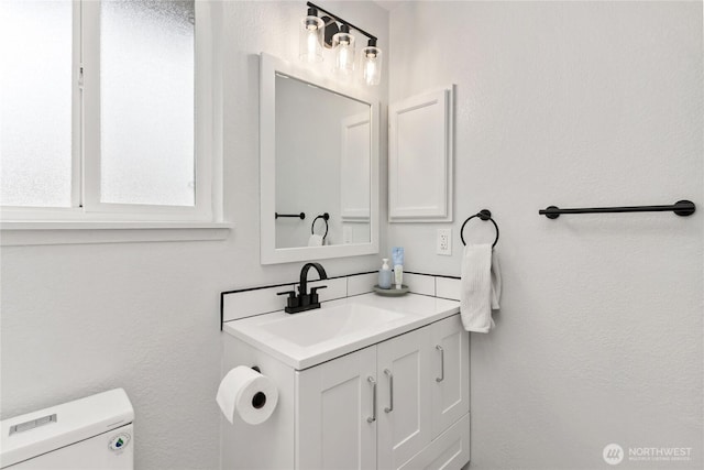 bathroom featuring toilet and vanity