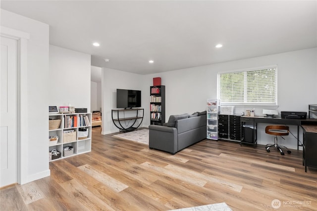living area with recessed lighting, baseboards, and wood finished floors