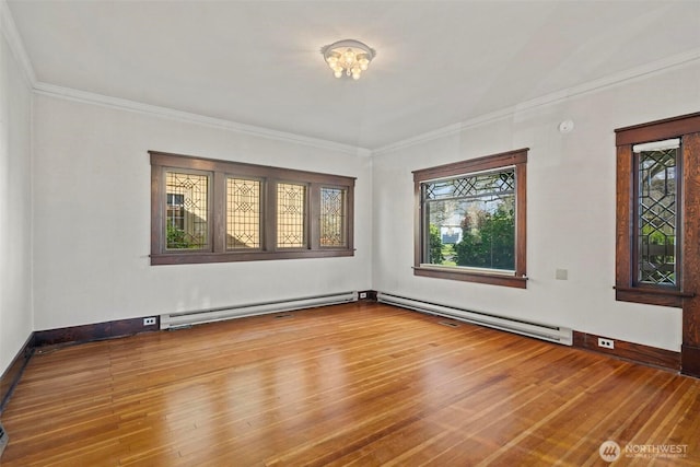 unfurnished room featuring wood finished floors, baseboards, baseboard heating, and ornamental molding