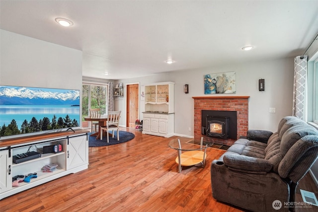 living area featuring light wood-style floors and recessed lighting