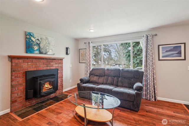 living room with baseboards, a fireplace, and wood finished floors