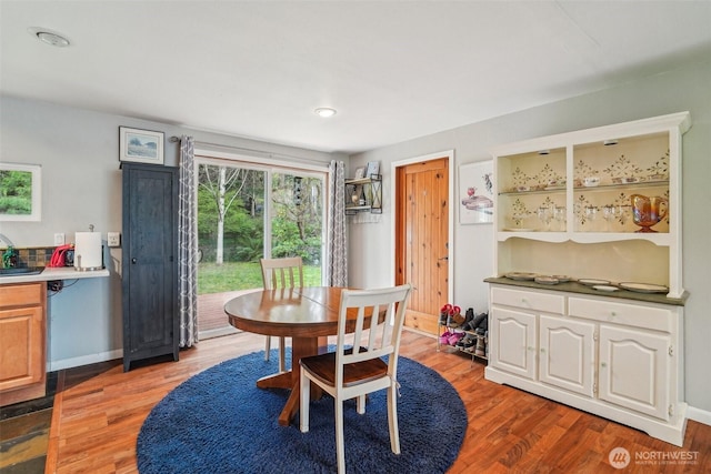 dining area featuring recessed lighting, baseboards, and wood finished floors