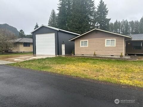 310 Kosmos Ln, Morton, WA 98356 - view of property exterior featuring an outbuilding, a lawn, a detached garage, and crawl space