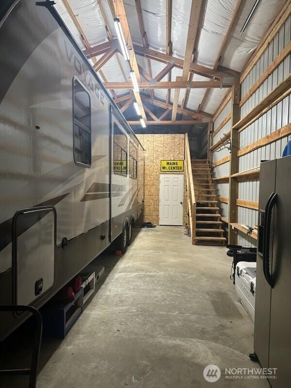 310 Kosmos Ln, Morton, WA 98356 - garage with black refrigerator with ice dispenser and metal wall