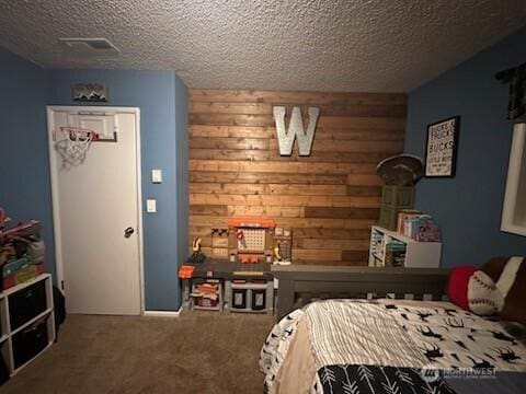 310 Kosmos Ln, Morton, WA 98356 - bedroom featuring wooden walls, visible vents, a textured ceiling, and carpet