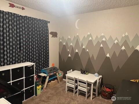 310 Kosmos Ln, Morton, WA 98356 - rec room featuring a textured ceiling and carpet flooring