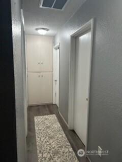 310 Kosmos Ln, Morton, WA 98356 - hall featuring wood finished floors and a textured wall