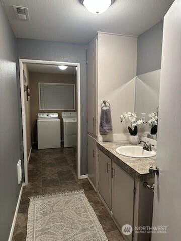 310 Kosmos Ln, Morton, WA 98356 - bathroom with vanity, visible vents, and washing machine and clothes dryer