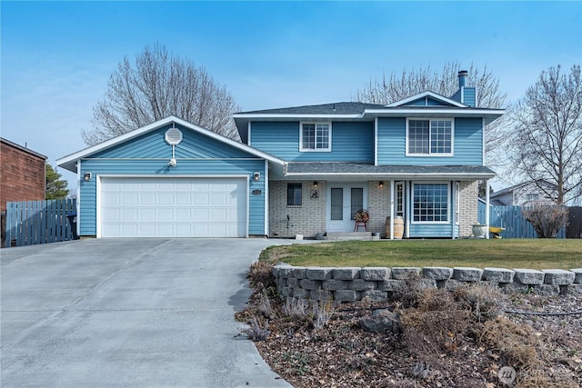 traditional-style house featuring fence, driveway, a chimney, a front lawn, and a garage