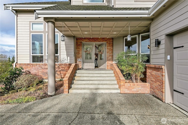 view of exterior entry with brick siding