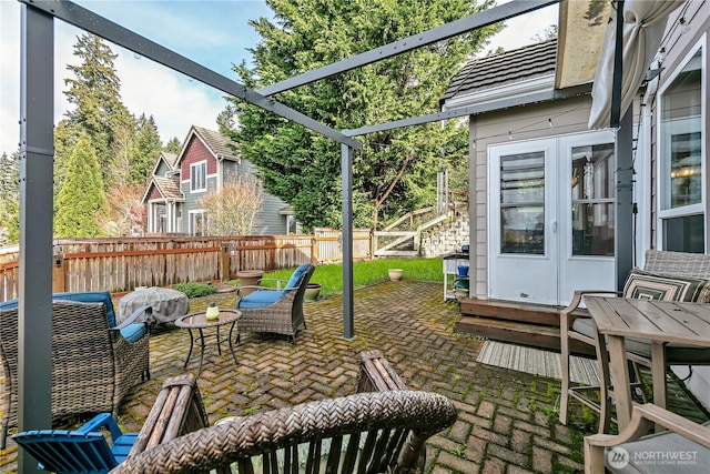 view of patio / terrace with an outdoor living space and fence