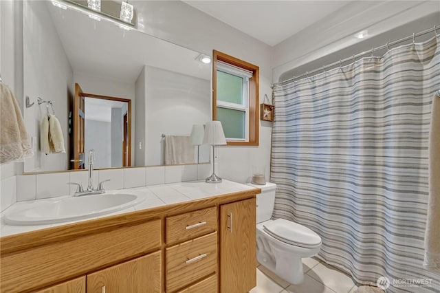 full bathroom with tile patterned floors, toilet, and vanity